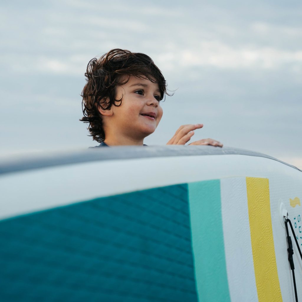 Child holding SeaVa paddleboard